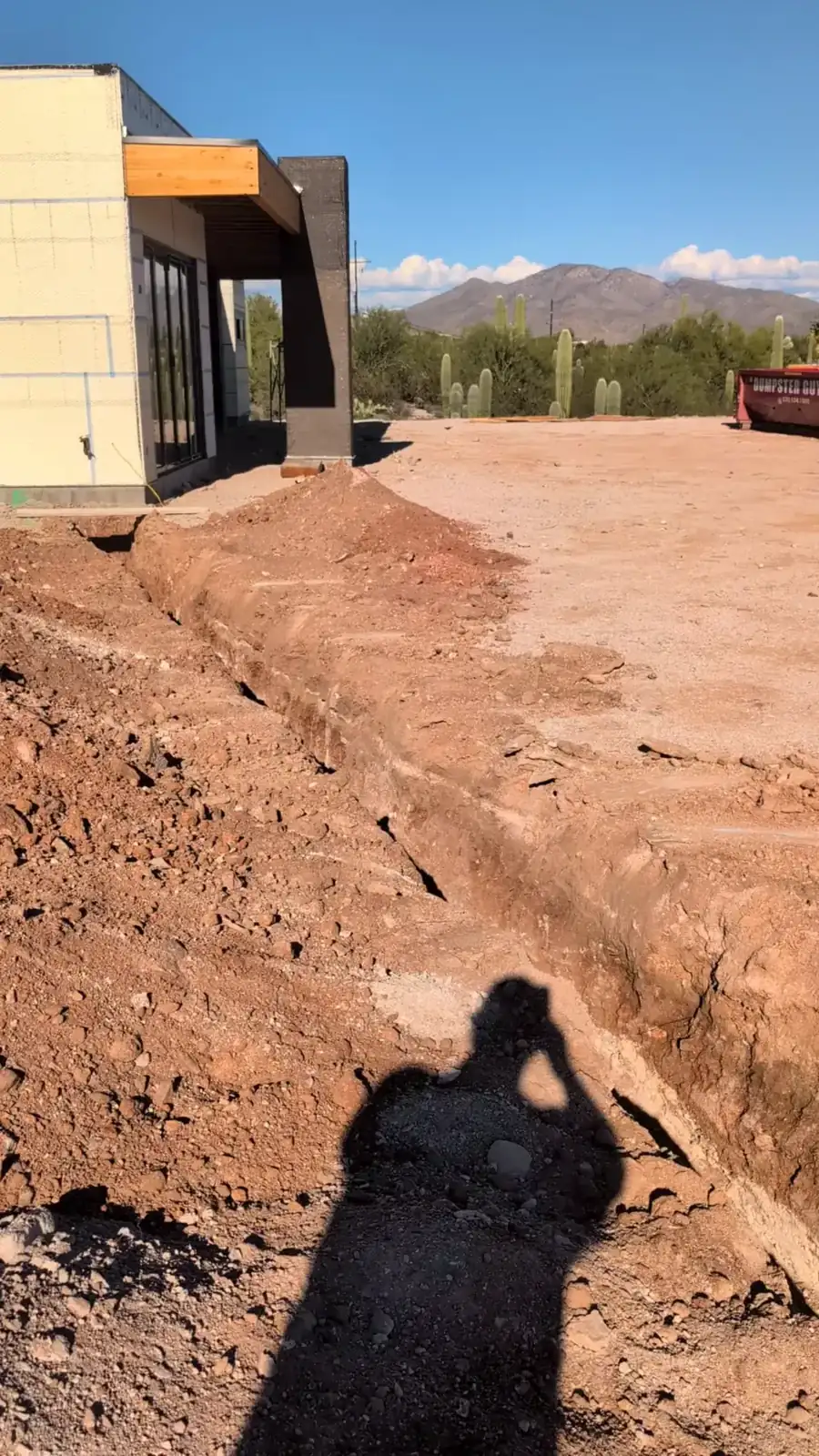 Utility trench running toward the custom home under construction