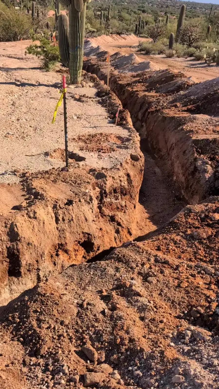 Rocky spoils windrowed beside the open trench